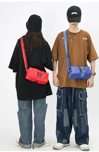 Detail showing waterproof oxford fabric and plastic buckle on red and blue crossbody bags