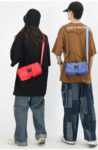 Detail of mini Oxford crossbody bag with large plastic buckle and adjustable strap