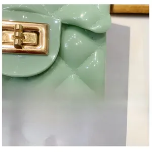 Macro shot of mint green jelly bag featuring quilted patterns and a gold metal twist lock