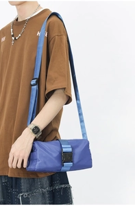 Blue cylindrical oxford cloth crossbody bag with adjustable strap and buckle detail