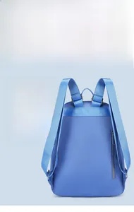 Detail of blue nylon backpack featuring adjustable metal buckles and anti-theft back pocket