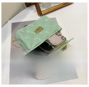 Detail of mint green quilted mini bag showing interior capacity for lipstick and makeup