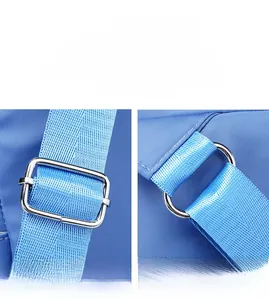 Detail of adjustable metal shoulder strap buckles and durable nylon webbing on blue backpack