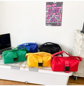 Detailed view of colorful oxford fabric crossbody bags with black buckle closure detail