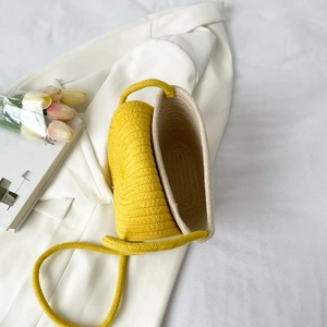 Détail du sac à bandoulière en paille tissé main en jaune vif et blanc crème
