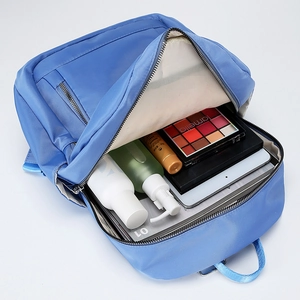 Bright blue nylon backpack showing large storage capacity for tablets and cosmetics