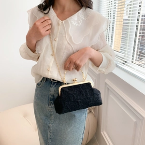 Retro black lace textured kiss-lock crossbody bag with gold chain and metal handle