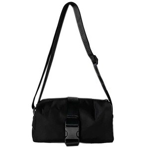 Detail showing the adjustable nylon strap and plastic buckle of the black crossbody bag