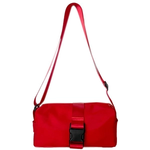 Close-up of bright red nylon crossbody bag featuring a durable black plastic buckle strap