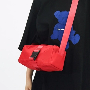 Red Oxford fabric crossbody gym bag with buckle closure and adjustable strap on a model