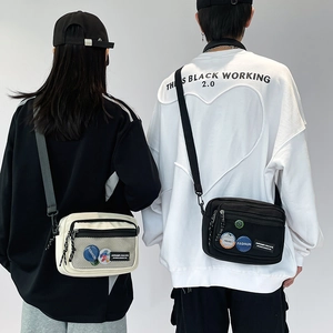 Detail of minimalist canvas crossbody bags in black and white with mesh pocket