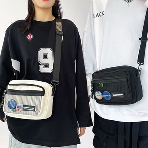 Detail showing durable canvas fabric with mesh pocket and adjustable shoulder strap