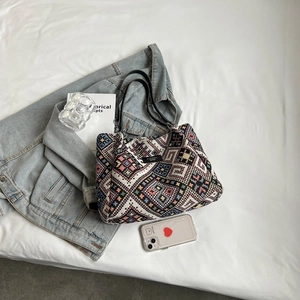 Retro ethnic style woven tote bag with colorful geometric patterns and black leather straps