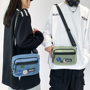 Dual view of blue and green nylon messenger bags with front mesh pocket and fashion patches