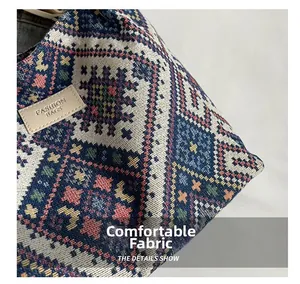 Macro detail of ethnic geometric woven knit fabric texture and leather fashion label