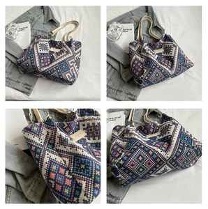 Detail showing bohemian geometric woven canvas pattern and decorative leather label on tote