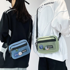 Close-up of casual canvas crossbody bags with mesh pockets in light blue and mint green