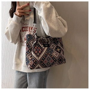 Detail of multi-color geometric woven tote bag with FASHION BAGS label and metal ring