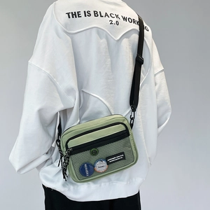 Minimalist light green canvas crossbody bag with mesh pocket and adjustable strap