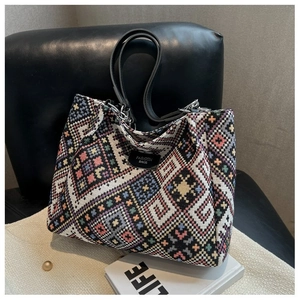 Detail view of ethnic tote bag with colorful geometric patterns and leather fashion tag