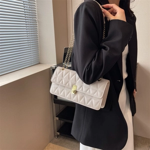 White quilted rectangular crossbody bag with gold chain strap and turn-lock closure