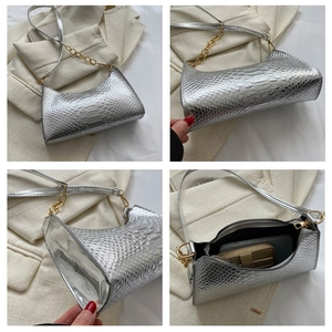 Detail view of silver snake-pattern shoulder bag with gold chain and inner space