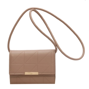 Beige quilted crossbody square bag with elegant gold metal trim and slim shoulder strap