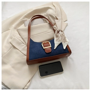Gros plan sur le sac en jean vintage avec finitions en cuir et détail foulard soie