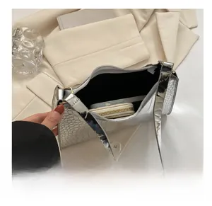 Interior view of silver crocodile texture bag showing space for phone and wallet