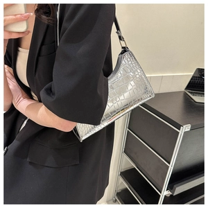 Silver crocodile pattern underarm bag on model showing stylish metallic PU leather texture