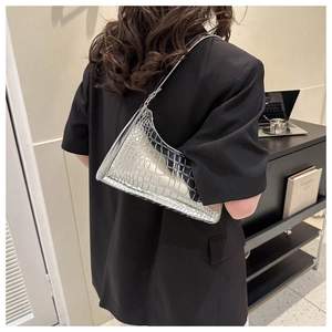 Silver faux crocodile texture underarm bag shown in a stylish minimalist setting