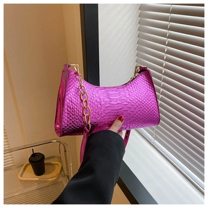 Pink snakeskin crescent underarm bag with gold chain and metal texture finish