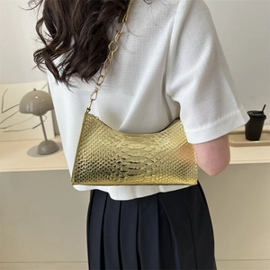 Golden snake skin baguette shoulder bag with chunky metal chain strap for women