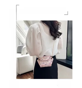 Detail view of pink geometric laser pattern on women mini crossbody bag with chain strap