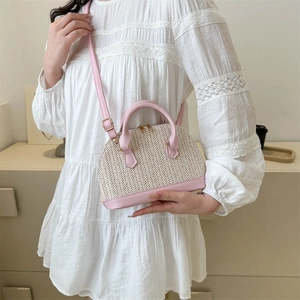 Women shell-shaped woven crossbody bag with pink leather trim and metal zipper