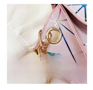 Close-up of pink geometric panel bag with gold metal hook and stylish chain detail