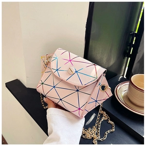 Detail of laser geometric crossbody bag with pink triangle tiles and gold chain strap