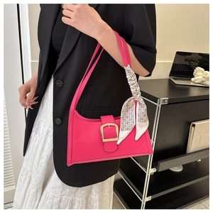Hot pink shoulder bag with golden buckle and patterned silk scarf detail on handle