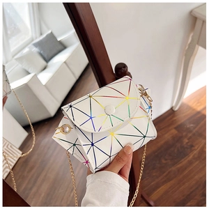 Detail of white geometric paneled crossbody bag with colorful iridescent gradient seams