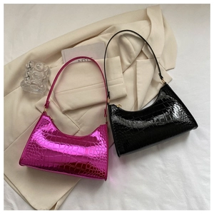 Detail shot of croissant bags in fuchsia metallic and black patent faux crocodile skin