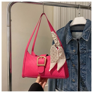 Detail of rose pink shoulder bag with gold square buckle and patterned silk scarf wrap