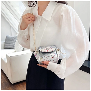 Detail of laser geometric crossbody bag with rainbow lines and golden chain strap