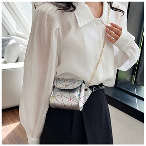 Detailed view of silver geometric mini crossbody bag with colorful stitching and gold chain