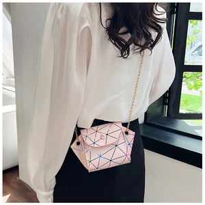 Detailed close-up of a pink geometric pattern mini bag with golden metal chain strap