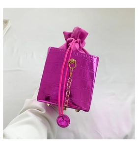 Dettaglio borsa fucsia con trama a coccodrillo, coulisse e piedini in metallo dorato