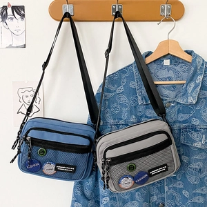 Detail view of retro canvas messenger bags with mesh pocket and adjustable nylon strap