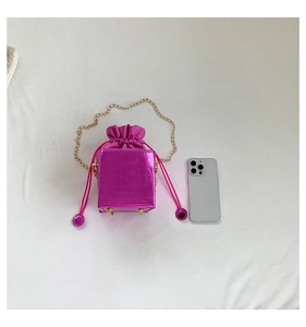 Vista dall'alto della borsa a secchiello fucsia a coccodrillo con catena d'oro e smartphone