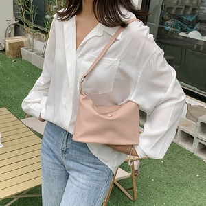 Chic pink leather half-moon underarm bag styled with casual white shirt and jeans