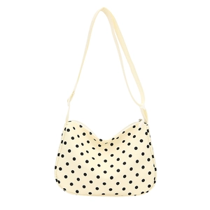 Detailweergave van de nylon crossbodytas met stippen, rits en schouderband