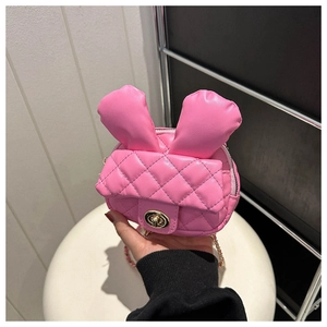 Close-up of pink mini crossbody bag featuring rabbit ears and gold twist lock detail